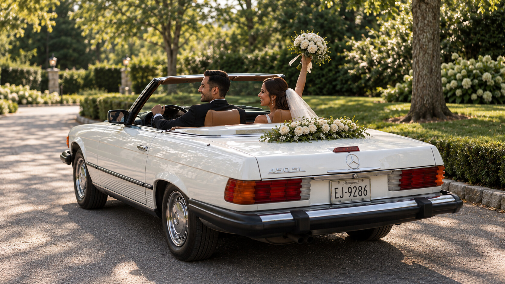 Bride and groom celebrating in a white Mercedes 450SL